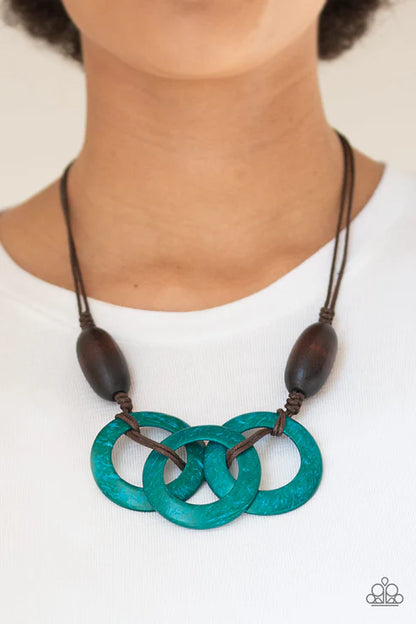Necklace with blue circular pendants and wooden beads on a white background