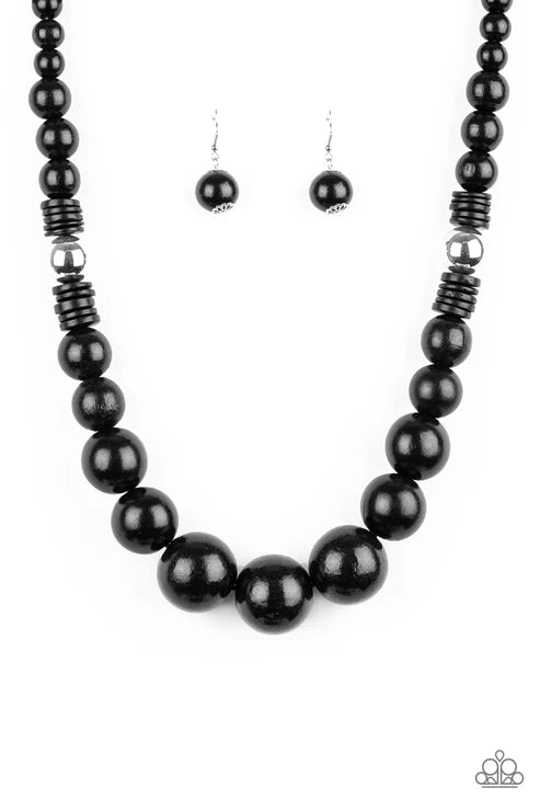 Black beaded necklace and earrings on a white background