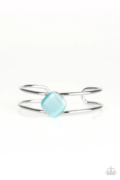 Silver ring with a turquoise gemstone on a white background