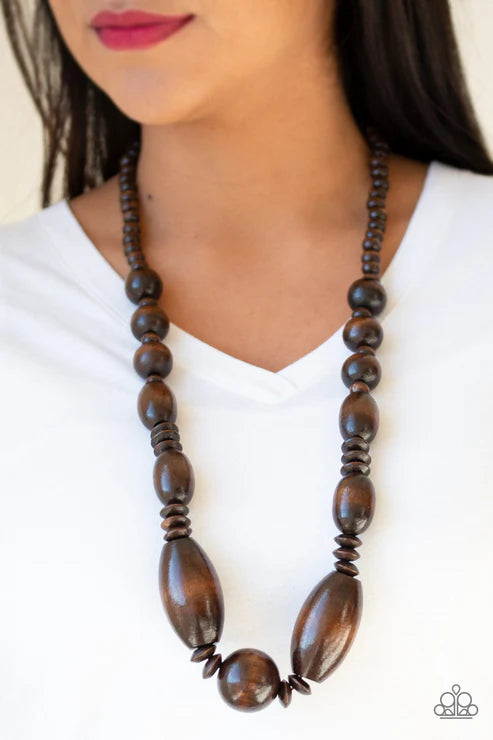 Wooden beaded necklace worn by a person on a white background