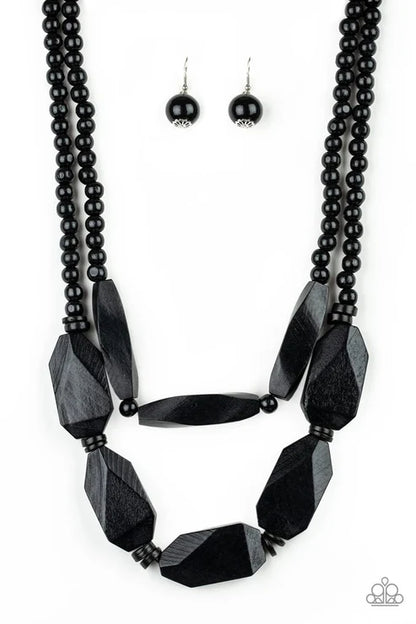 Black beaded necklace and earrings on a white background
