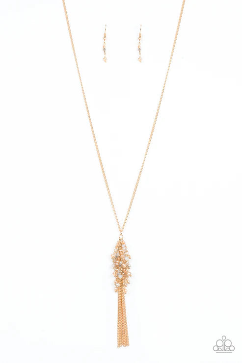 Gold necklace with tassel on a white background
