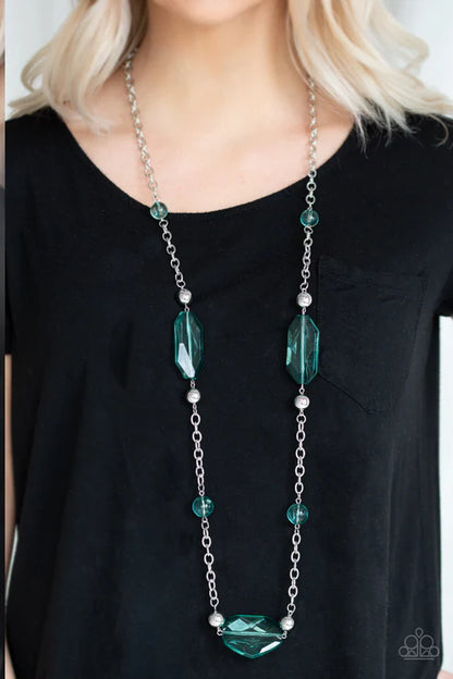 Long green beaded necklace worn by a person on a black background