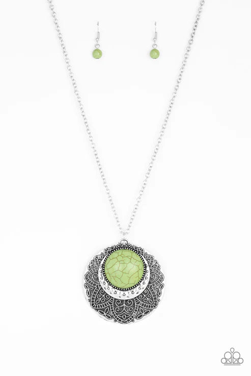Necklace with green pendant and matching earrings on a white background