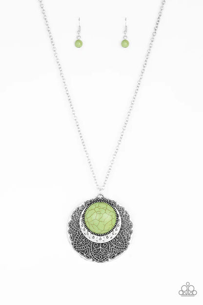 Necklace with green pendant and matching earrings on a white background