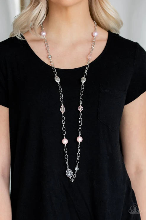 Long necklace with pink beads and silver chain on a black shirt