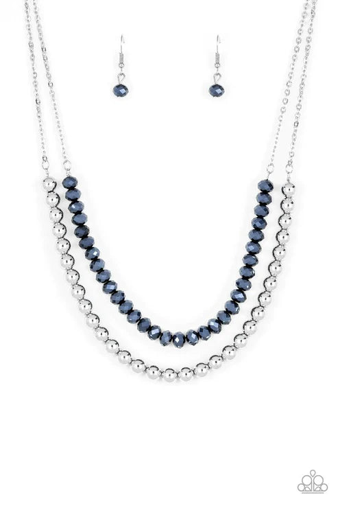Necklace and earrings set with blue and silver beads on a white background