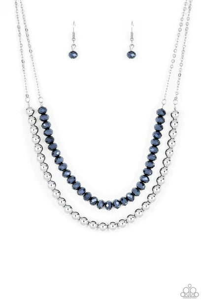 Necklace and earrings set with blue and silver beads on a white background