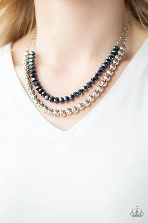 Necklace with blue and silver beads on a white background