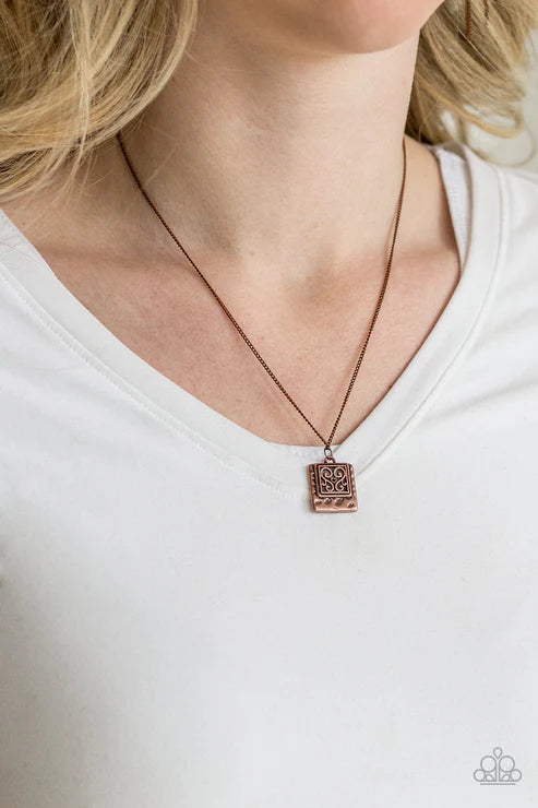 Necklace with a pendant worn by a person on a white background