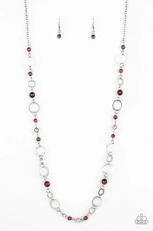 Necklace and earrings set with red beads and silver chain on a white background