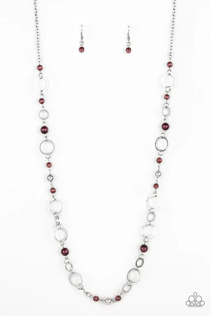 Necklace and earrings set with red beads and silver chain on a white background