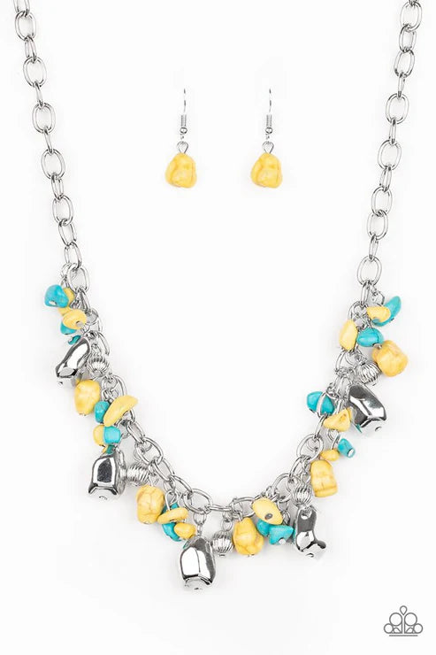Necklace and earrings set with yellow and blue charms on a white background