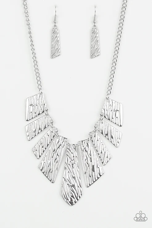 Silver necklace with geometric design on a white background