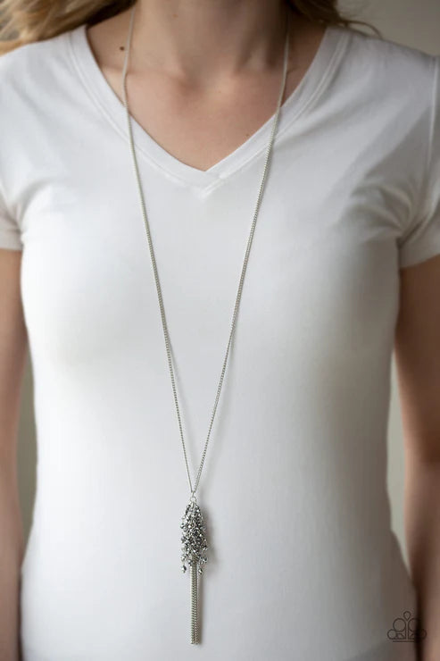 Long necklace with a pendant on a white shirt