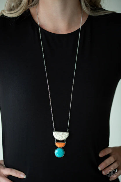 Long necklace with colorful pendant on a black shirt