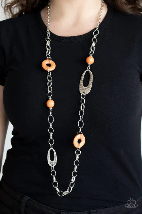 Long necklace with orange beads and silver chain on a black shirt