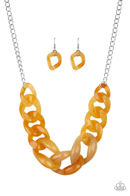 Orange chain necklace and earrings on a white background