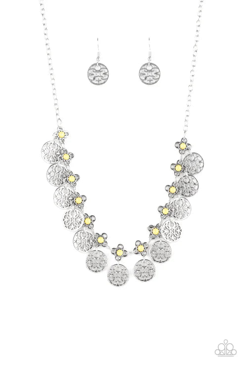 Silver floral necklace and earrings on a white background
