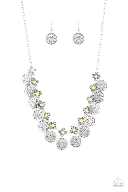 Silver floral necklace and earrings on a white background