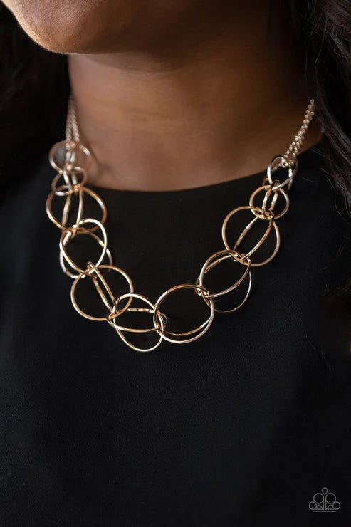 Gold chain necklace on a black background