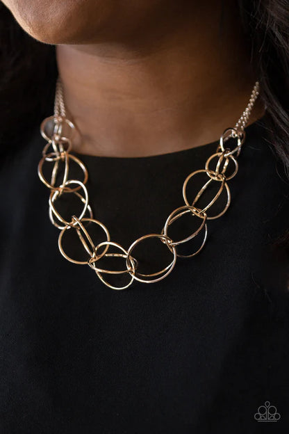 Gold chain necklace on a black background