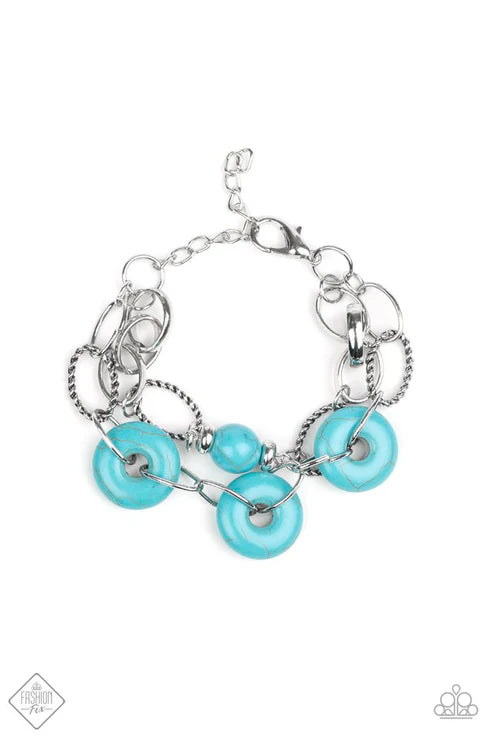 Silver bracelet with turquoise beads on a white background