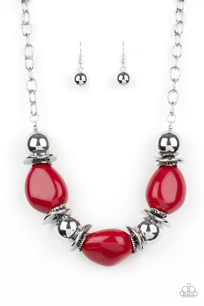 Necklace with red teardrop beads and silver accents on a white background