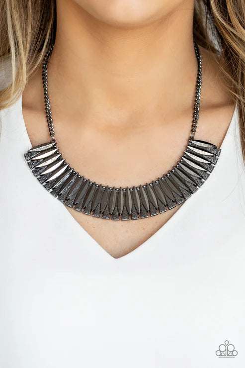 Necklace with metallic, fan-shaped pendants on a white background