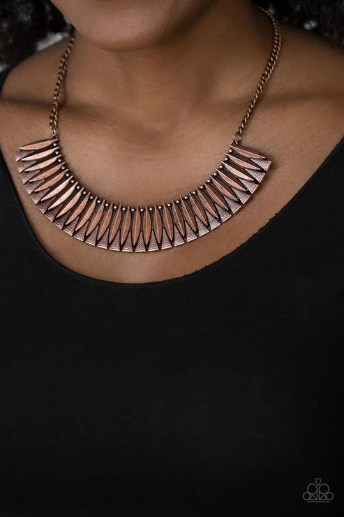 Copper necklace with geometric design on a black background