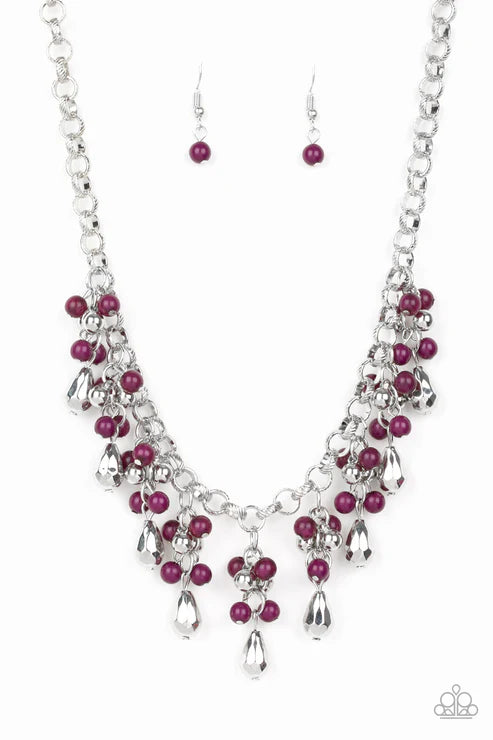 Necklace and earrings set with pink beads on a white background