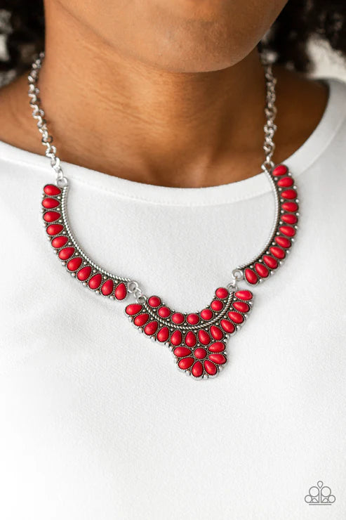 Red beaded necklace on a white background
