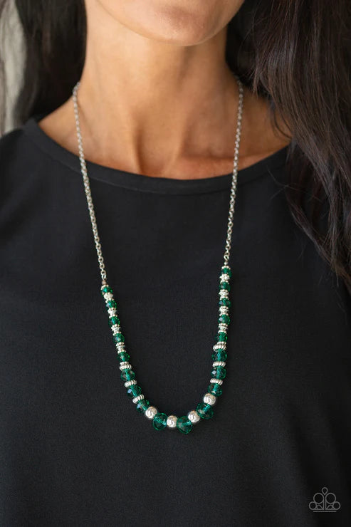 Green beaded necklace worn by a person on a black background