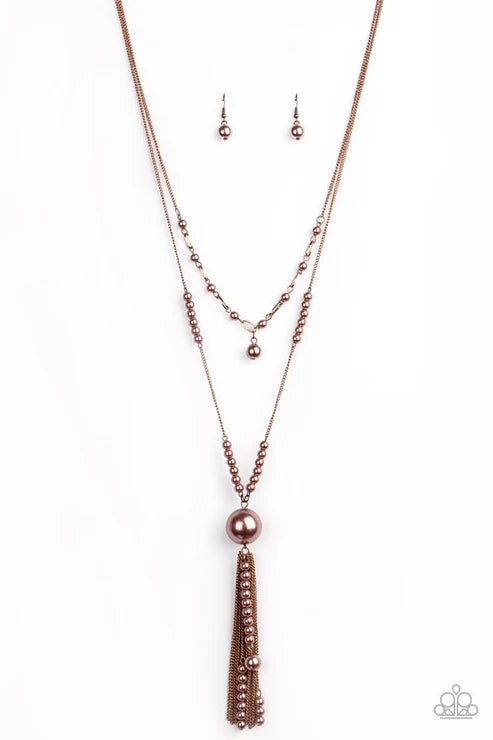 Rose gold necklace and earring set on a white background