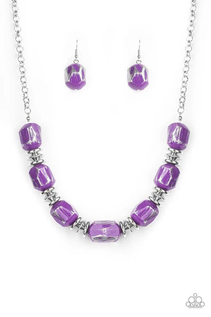 Purple beaded necklace and earrings on a white background