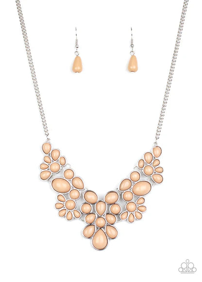 Necklace and earrings set with peach-colored stones on a white background