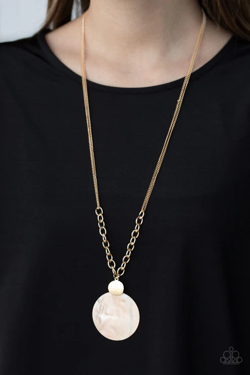 Necklace with a large beige pendant on a black background