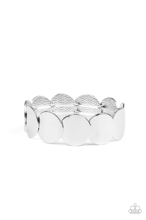 Silver bracelet with scalloped edges on a white background