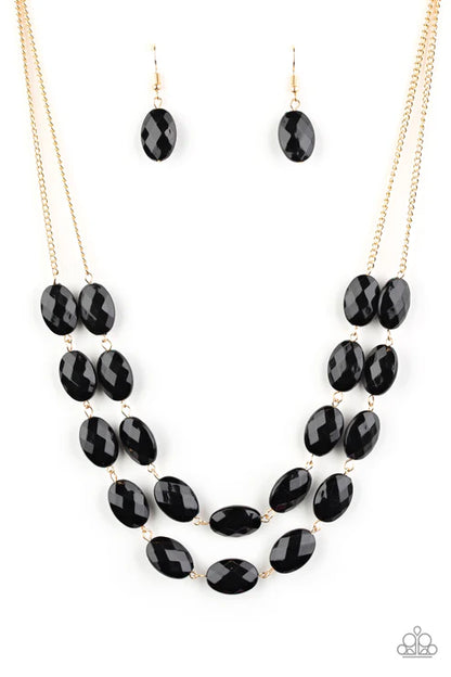 Black beaded necklace and earrings on a white background