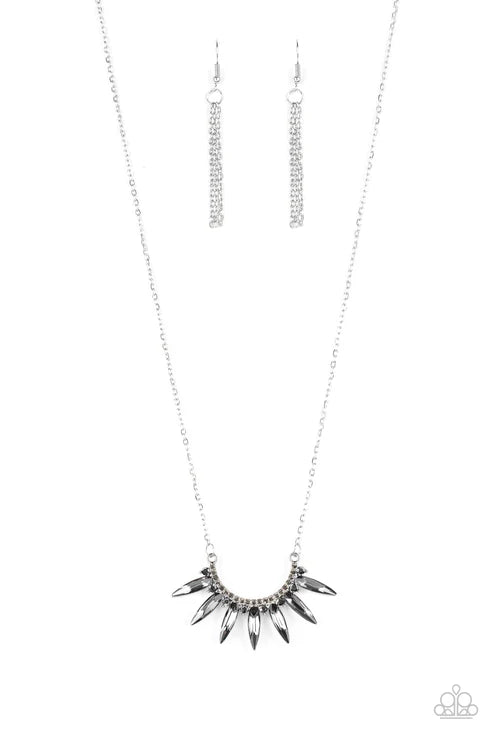 Silver necklace with spike-like pendant on a white background