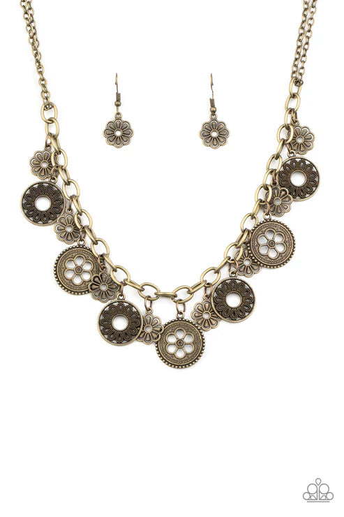 Necklace and earrings set with circular designs on a white background