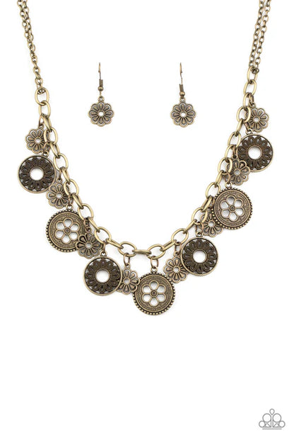 Necklace and earrings set with circular designs on a white background
