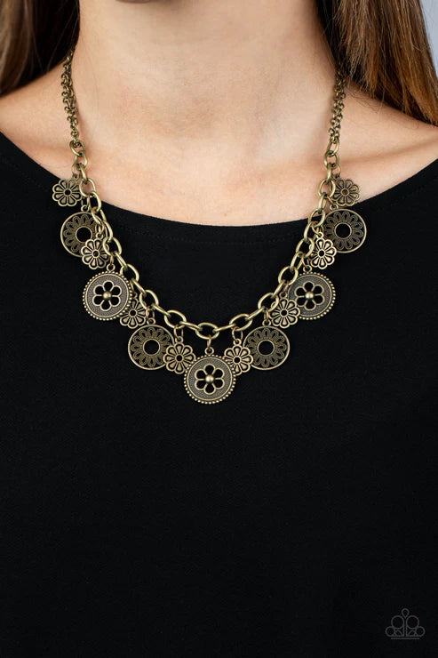 Gold necklace with circular pendants on a black background