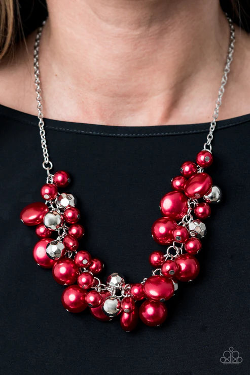 Necklace with red and silver beads on a black background