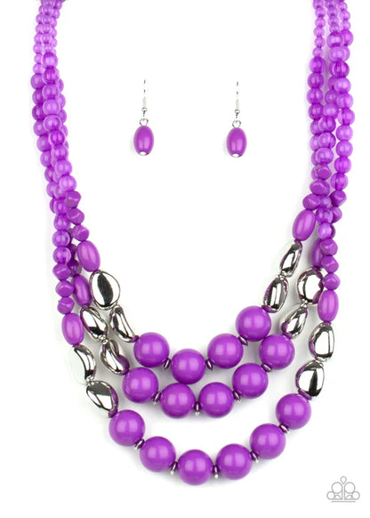 Purple beaded necklace and earrings on a white background