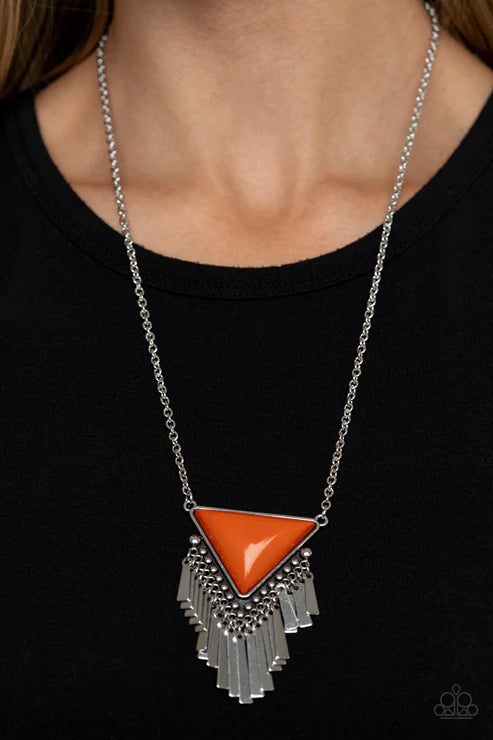 Necklace with a red triangle pendant and silver fringe on a black background