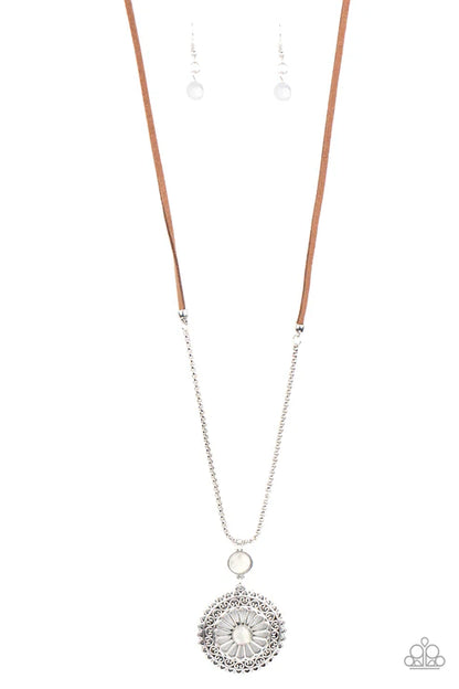 Silver necklace with a circular pendant on a white background