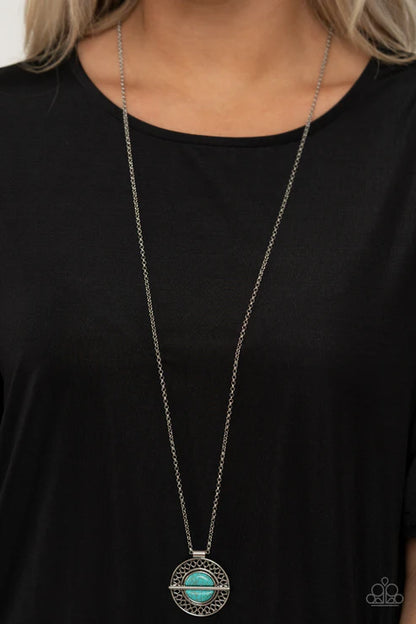 Long necklace with a turquoise pendant on a black shirt