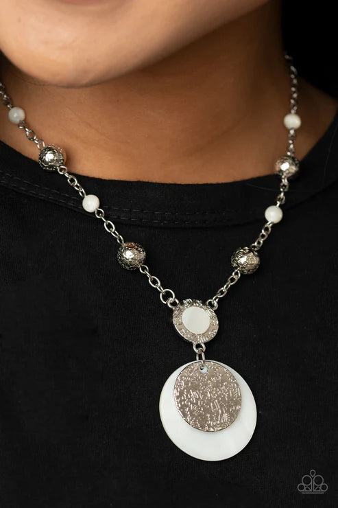 Necklace with white and silver pendant on a black background