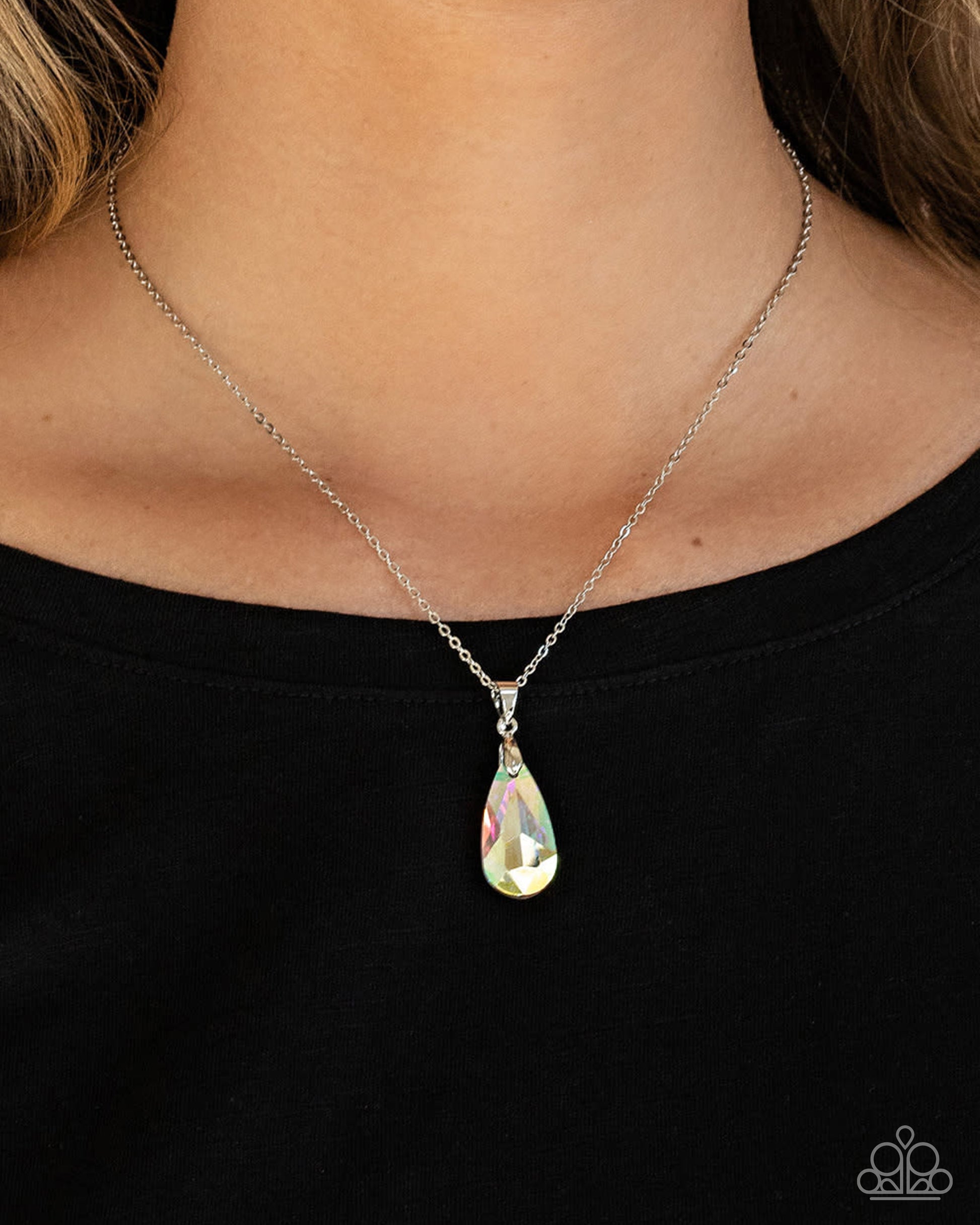 Necklace with a teardrop-shaped pendant on a black background